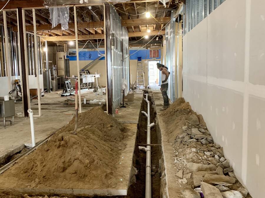 Trench cut through a commercial building floor for new underground drain lines